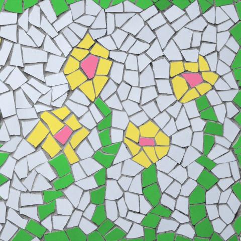 mosaic of white yellow pink and green tiles that make a design of multiple flowers via canva