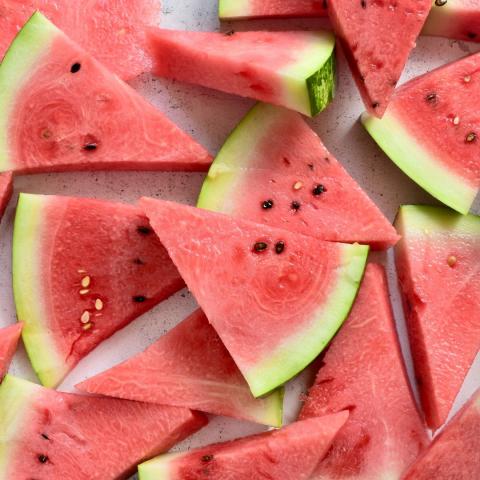 a pile of triangle cut watermelon slices via Canva